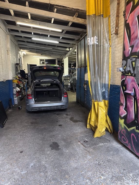 Inside the Balls Pond Garage workshop with a car being worked on